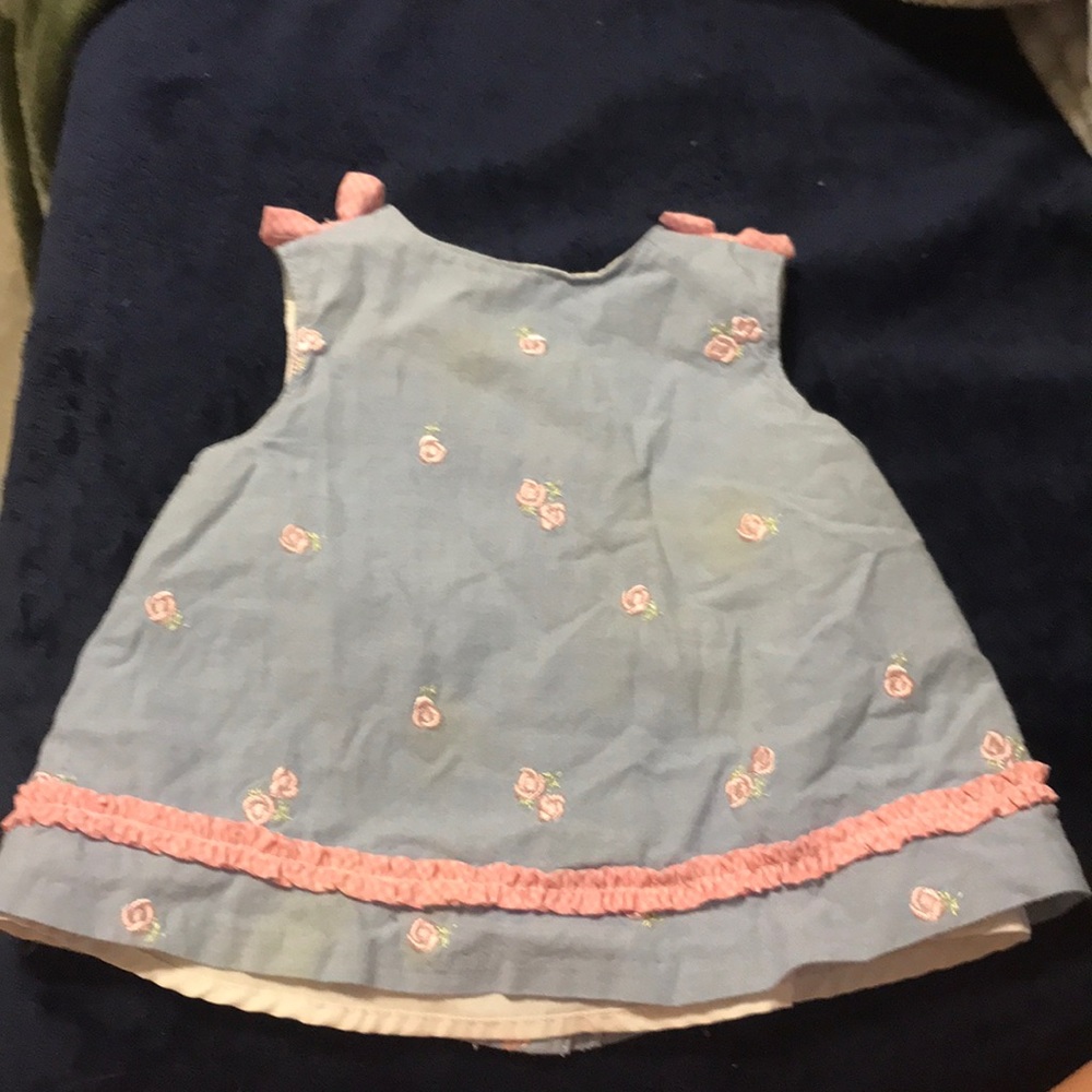 Embroidered flowers  ruffles at the bottom to the bows on the sleeves